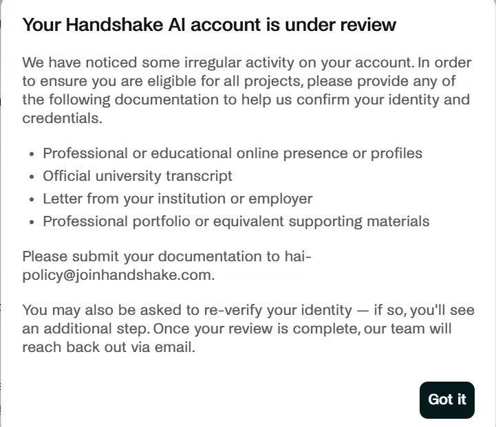 Handshake AI account-under-review screen asking the contributor to submit a university transcript or institution letter to confirm identity